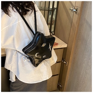 Star-shaped black crossbody bag with silver celestial charms and chain strap detail