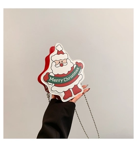 Detail showing the cartoon Santa Claus leather crossbody bag with Merry Christmas text