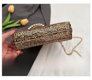 Detailed close-up of gold sequin evening bag showing the tight sequin layout and base view