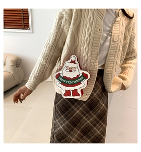 Close-up of Santa Claus crossbody bag with metal chain strap and Merry Christmas text