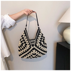 Detail of hand-woven crochet shoulder bag featuring black and white geometric contrast