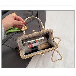 Detail view showing interior capacity of a vintage brown sequin evening bag with gold chain