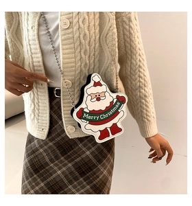 Close-up of a Santa Claus crossbody bag with silver bead chain strap on model outfit