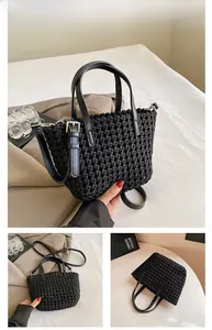 Detail view of black woven bucket bag showing premium leather texture and silver hardware