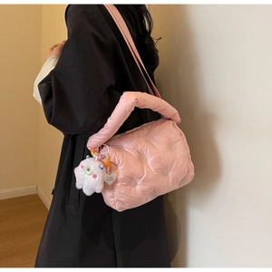 Pink quilted down nylon shoulder bag with cute plush monster charm and heart tag