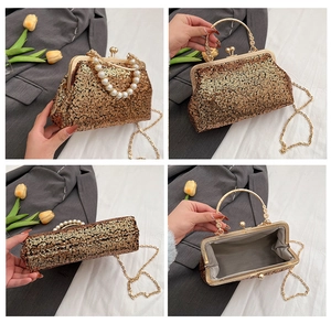 Detailed close-up of golden sequin evening clutch featuring retro metal clasp and pearl handle