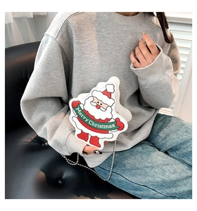Close-up of Santa Claus crossbody bag with silver ball chain and Merry Christmas slogan