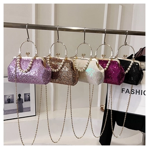 Detail of sequined evening bags with pearl handles and metallic gold chain straps