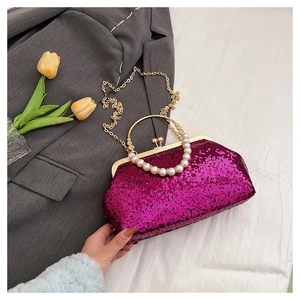 Macro detail of luxury purple sequin evening bag with pearl handle and gold chain