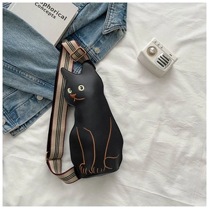 Detail of creative black cat leather crossbody bag with embroidered face and striped strap