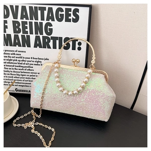 Detail of pink iridescent sequin evening bag with gold ring handle and pearl strap