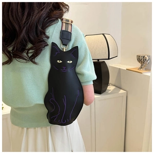 Close-up of cat-shaped leather crossbody bag with purple stitching and checkered strap