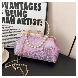 Detail of sequined purple evening bag featuring gold metal handle and pearl chain link