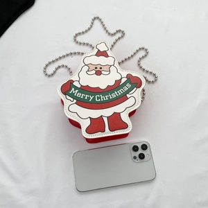 Santa Claus themed crossbody bag with silver chain and Merry Christmas print next to a phone