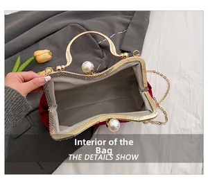 Detail showing the spacious interior of red velvet evening bag with pearl clasp closure