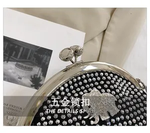 Close-up of sparkling rhinestone evening bag featuring an elephant metal clasp lock