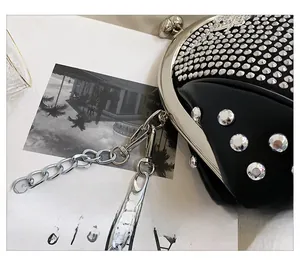 Detail of silver rhinestone and stud embellishments on a black shell evening bag