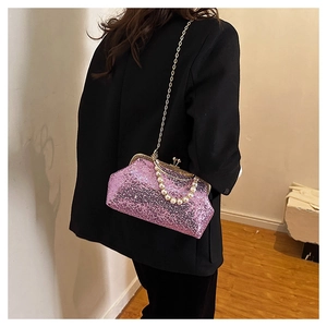 Detailed view of shimmering purple sequin handbag with pearl handle and gold chain strap