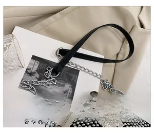 Detail show of comfortable wide leather and silver metal chain strap on rhinestone shell bag
