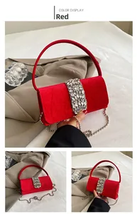 Detail view of red velvet evening bag with crystal buckle and silver chain strap