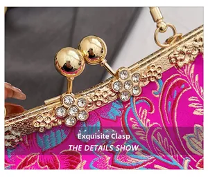 Detailed close-up of the vintage silk bag with golden rhinestone clasp and floral embroidery