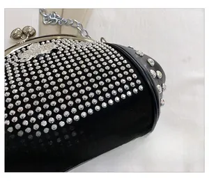 Detail shot of black shell bag featuring shimmering silver rhinestones and metal chain strap