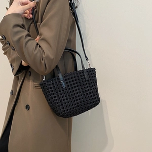 Handmade black woven bucket bag with leather handles and adjustable shoulder strap