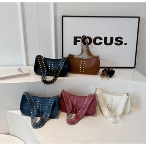 Close-up of five colors of vintage rivet crescent shoulder bags in matte leather
