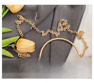 Detail of red silk bag with flower embroidery, gold metal handle and rhinestone clasp