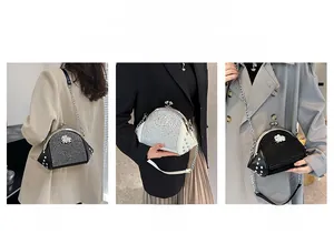 Detail view of rivet and rhinestone encrusted shell bag worn on shoulder and crossbody
