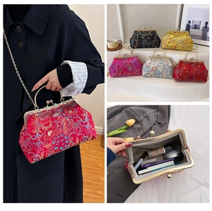 Detail view of the embroidered silk handbag interior showing capacity for cosmetics and phone