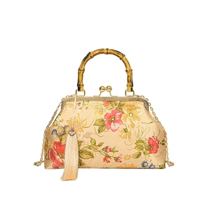 New Chinese shell bag with bamboo handle, floral silk pattern, and gold tassel chain