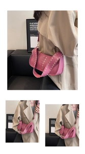 Detail view of pink biker shoulder bag with silver rivet studs and sleek leather texture