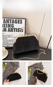 Detail of vintage black shell evening bag with golden vertical stripes and ring handle