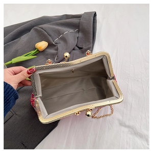 Detail view of the vintage embroidered handbag interior with gray lining and gold frame