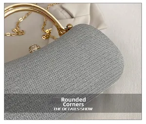 Detail of silver glitter clutch with gold handle, rhinestones and rounded edges