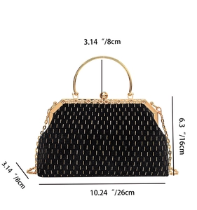 Detail of vintage black shell clutch with gold stitching and metal dimensions