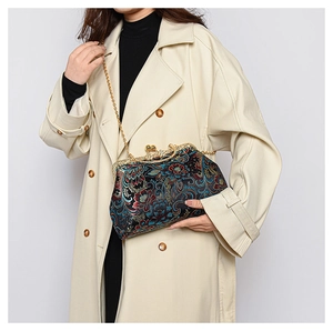 Detail of embroidered floral brocade bag with vintage gold clasp and chain strap