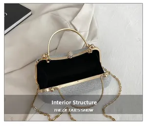 Silver glitter evening bag interior with black fabric lining and gold chain strap