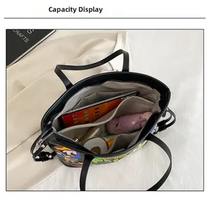 Internal view of the black tote bag showing pockets, tablet, and daily essentials