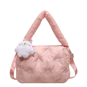 Pink quilted puffer bag with plush monster pendant and adjustable strap for women