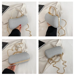 Detail view of silver glitter evening bag with gold chain strap and rhinestone handle