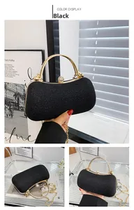 Close-up of black evening clutch with sparkling finish, gold handle and rhinestone lock