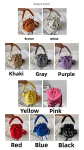 Detail showcasing variety of colors and suede texture of the THE BUCKET crossbody bag