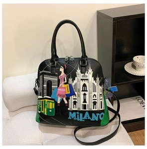 Dettaglio ricamo Milano su borsa a conchiglia nera con manico e vista cerniera