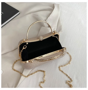Close-up of champagne gold sequined evening bag with rhinestone ring handle and metal chain