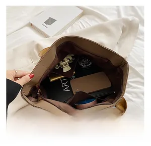 Top view of brown tote bag interior capacity with daily items and zipper pocket
