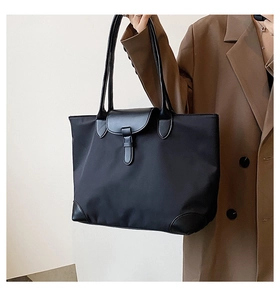 Classic black nylon tote bag with leather details styled on a brown blazer outfit