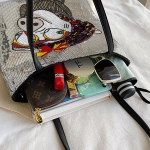 Interior view of silver sequin tote bag showing large capacity and cartoon character detail