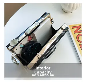Detail view of the vintage camera-shaped box bag interior holding cosmetic essentials